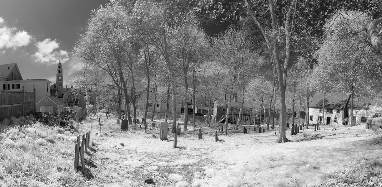 Panoramic Infrared Photo of Urban New England Graveyard With Church Steeple in Background.